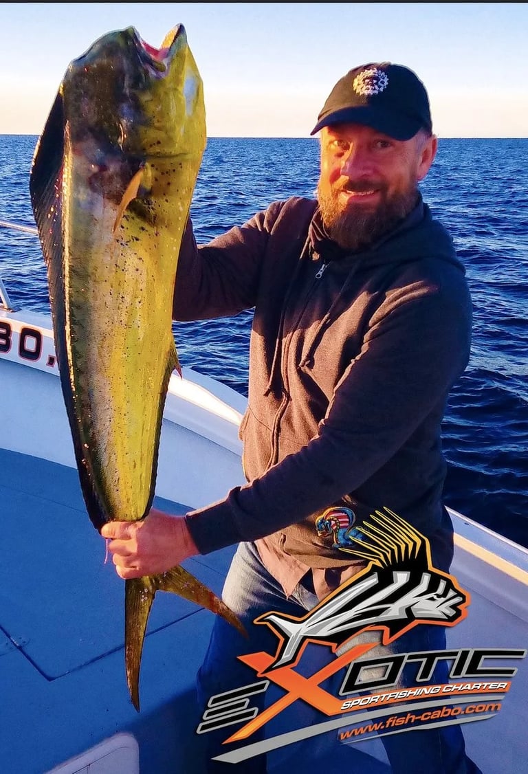 a man holding a fish fish on a boat