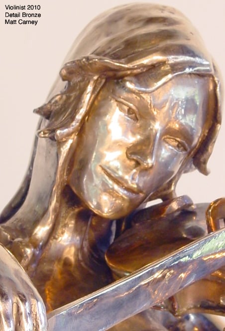 a statue of a woman holding a bow to a violin