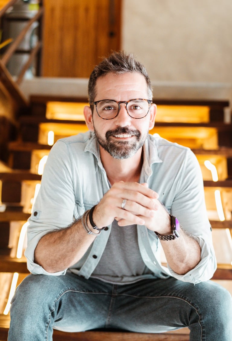 professional photo of Michael Franco, HR and employee engagement leader, smiling on a stair case.  