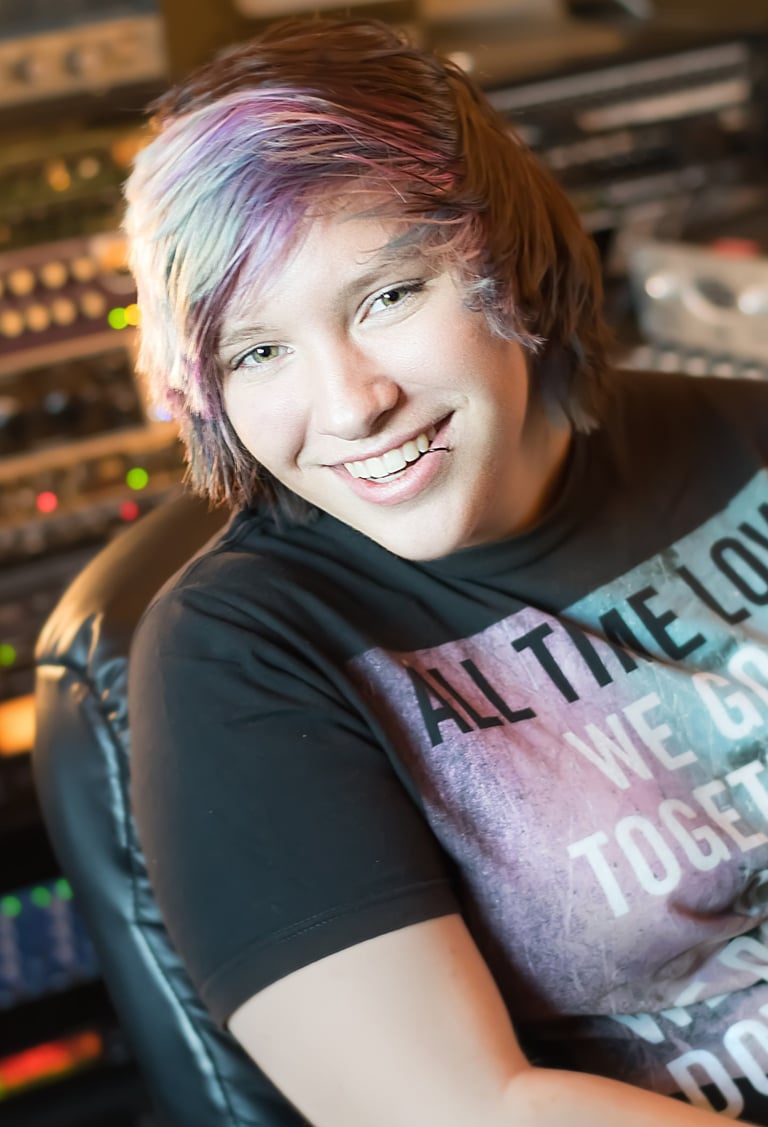 a woman with a colorful hair and a black shirt