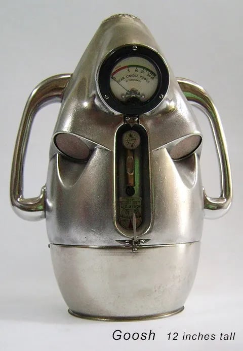 Found object robot head built by artist Tal Avitzur from vintage headlamp tester.