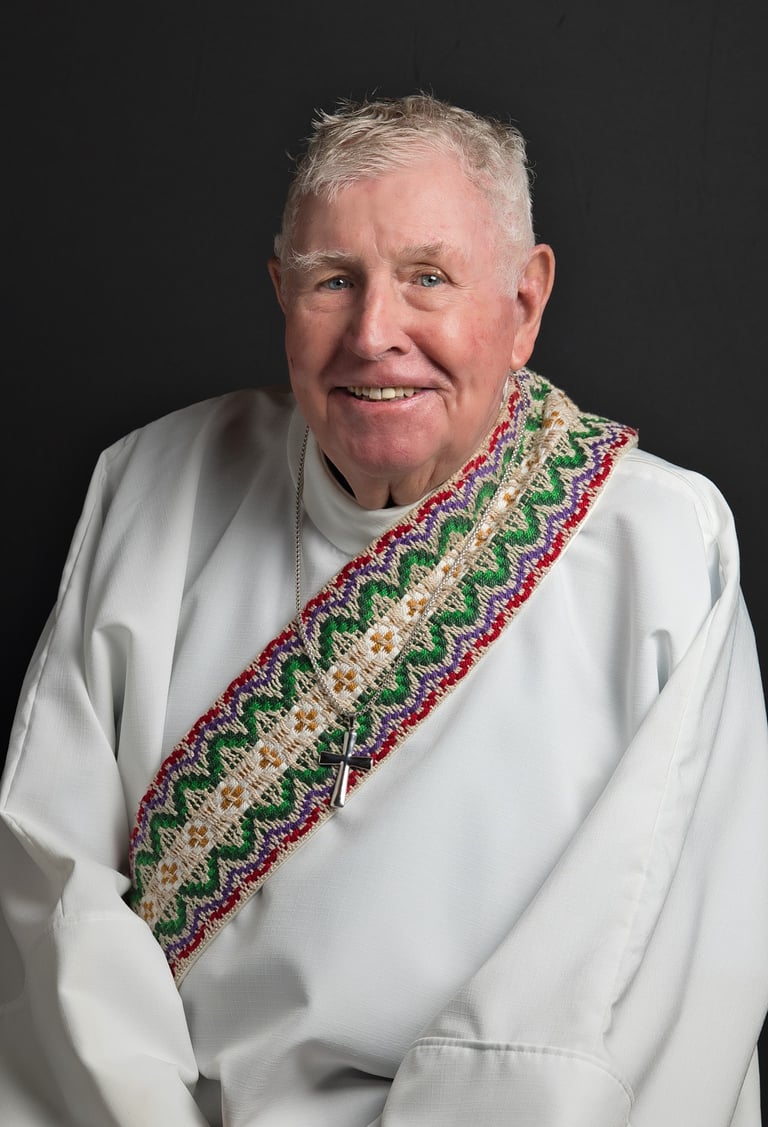a man in a white shirt of church clergy and a tie dye on his neck