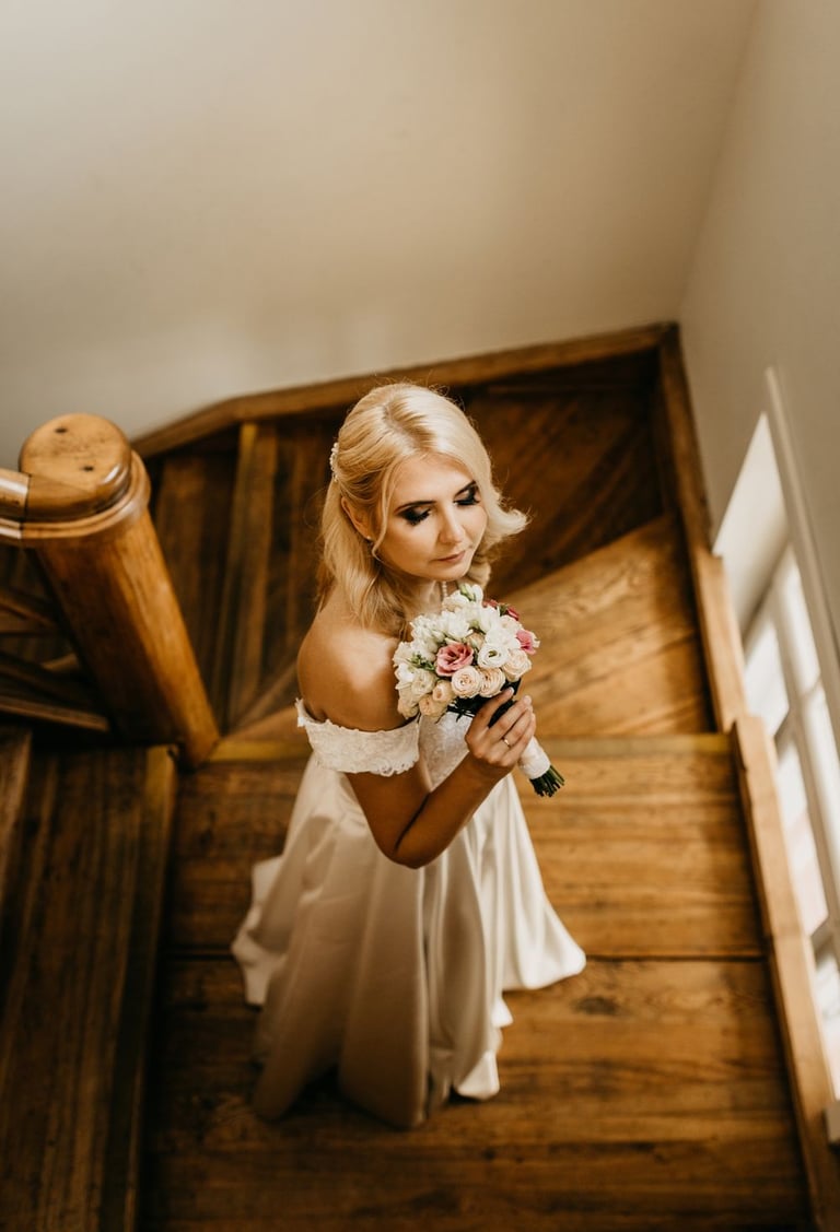 a bridesmaid in a white dress and a bouquet