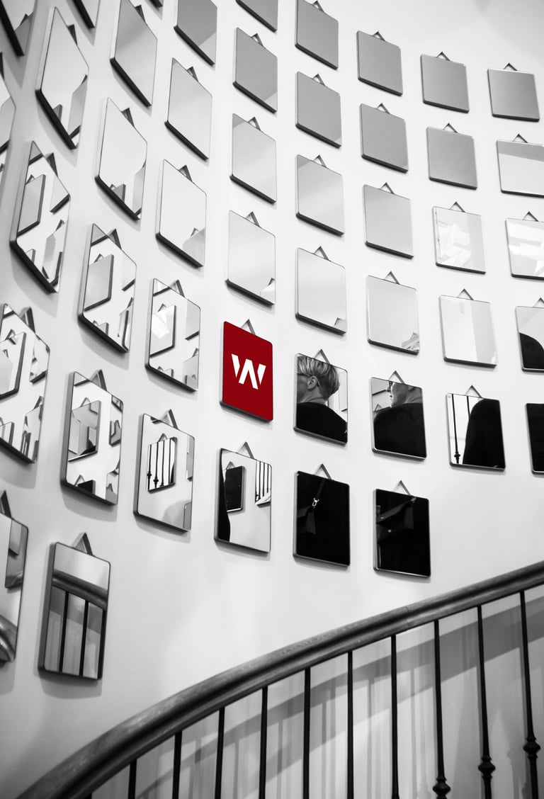 a wall of mirrors with a red light on it
