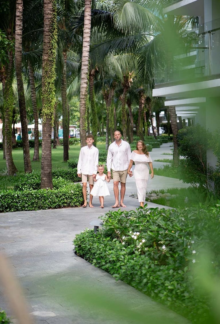 Family walking through Premier Residences Phu Quoc gardens