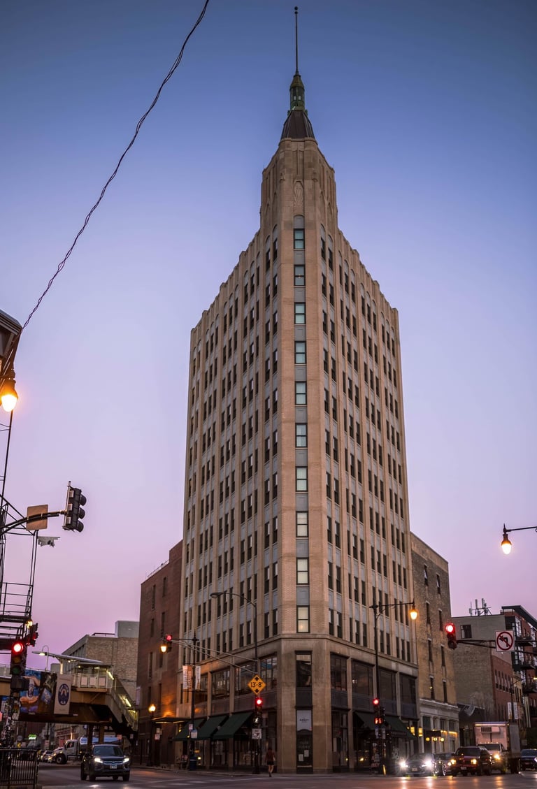 a tall building with a clock tower in the middle of the street