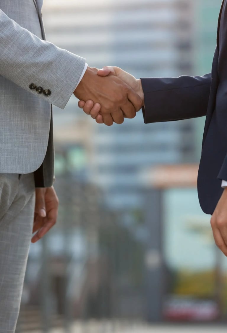 International business partners shaking hands to establish pharmacovigilance collaborationInternatio