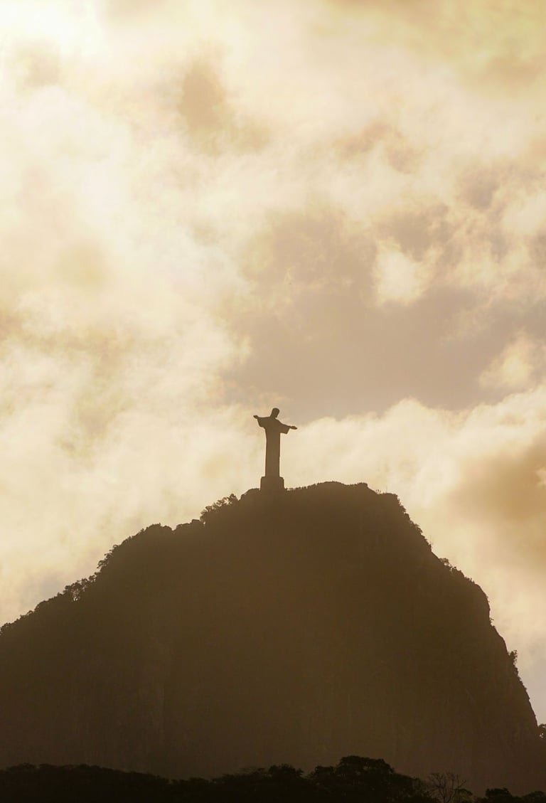 a statue of christ christ on a mountain top