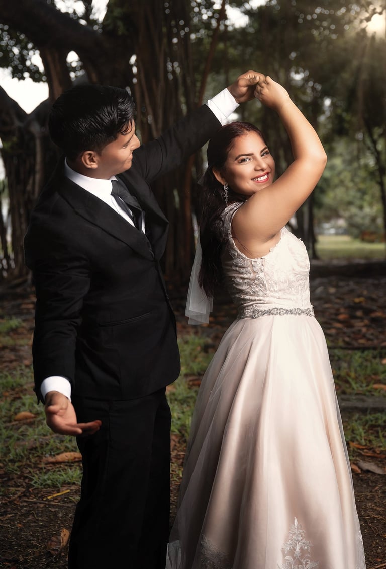a man and woman in formal wear standing in a park