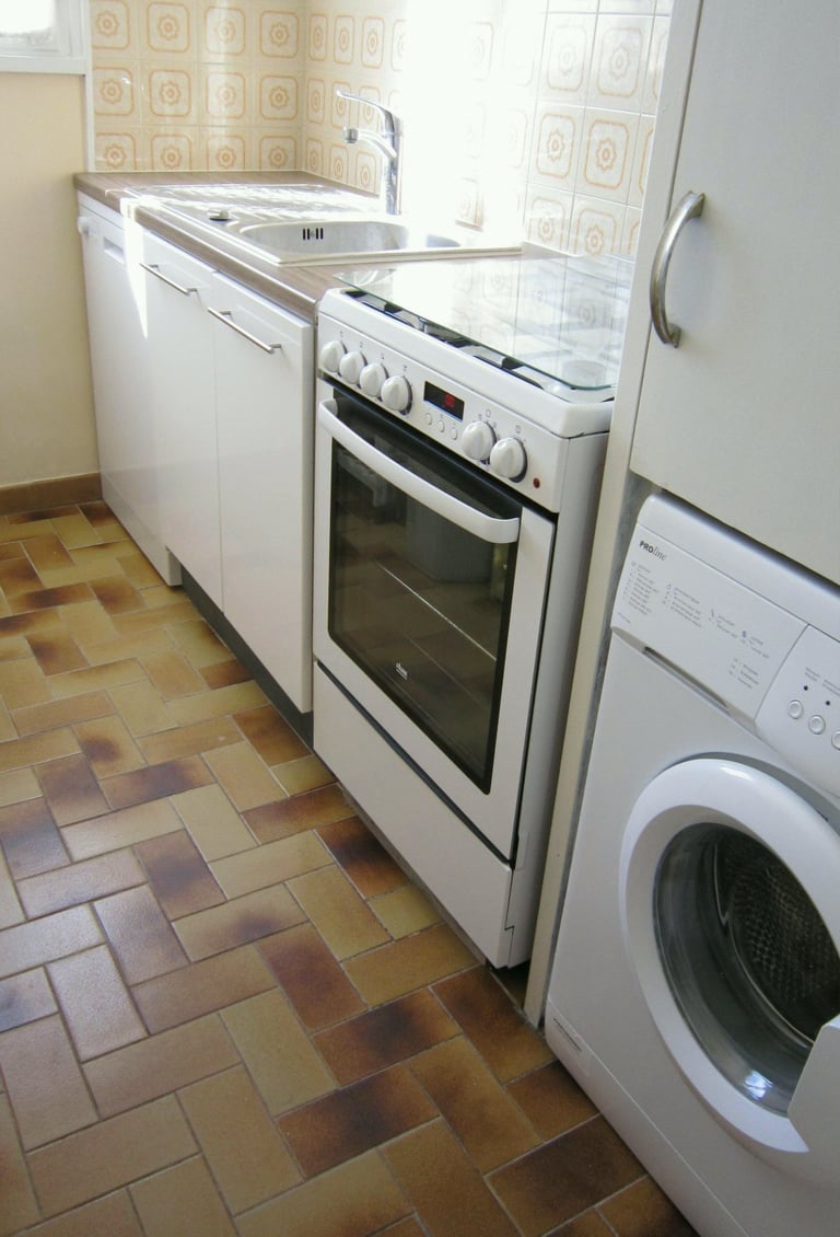 a kitchen with a washing machine and a washing machine