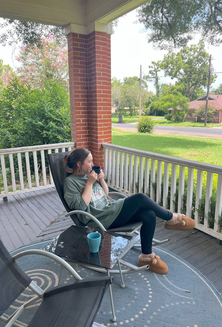 Woman sitting drinking coffee at Main Street House