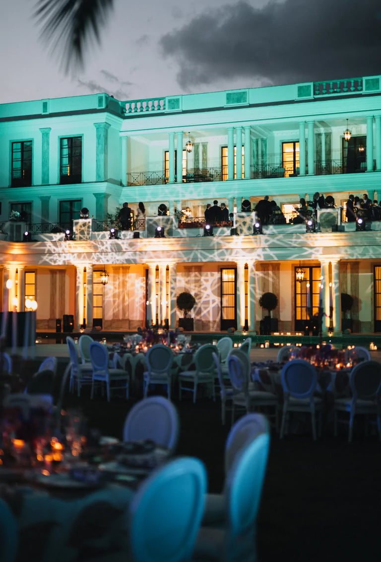 Evening reception in front of illuminated villa façade