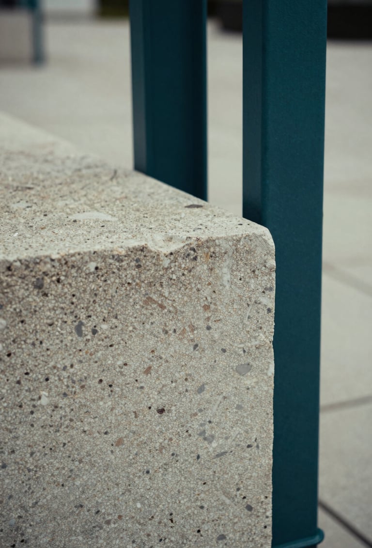Macro photography of weathered stone and modern steel interfaces in a public plaza. The palette consists of soft sage and deep sea teal shadows. Professional, close-up composition.