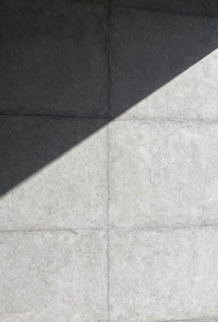 Large-scale architectural photography of a concrete wall in Stockholm. A single sharp shadow cuts across the surface. Minimalist, clean lines, professional composition with silver and dark gray tones.
