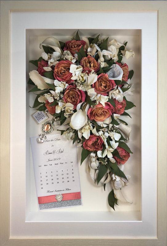 trailing view preserved wedding bouquet with keepsakes in a frame