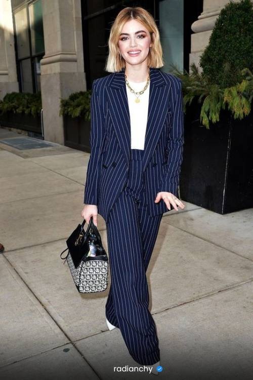 a woman in a suit and white shirt