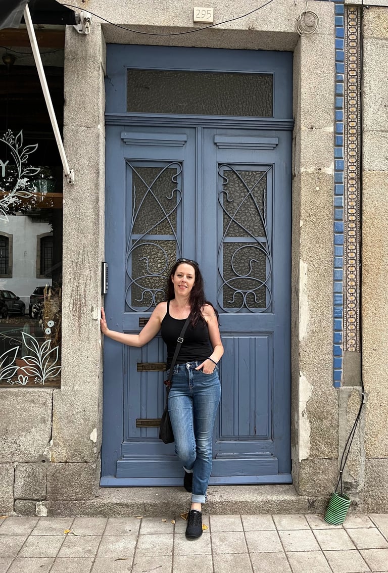 a woman standing in front of a blue door