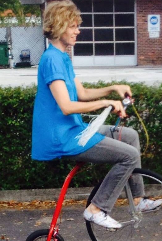 Image of author Dawn Davies riding a large front-wheel tricycle