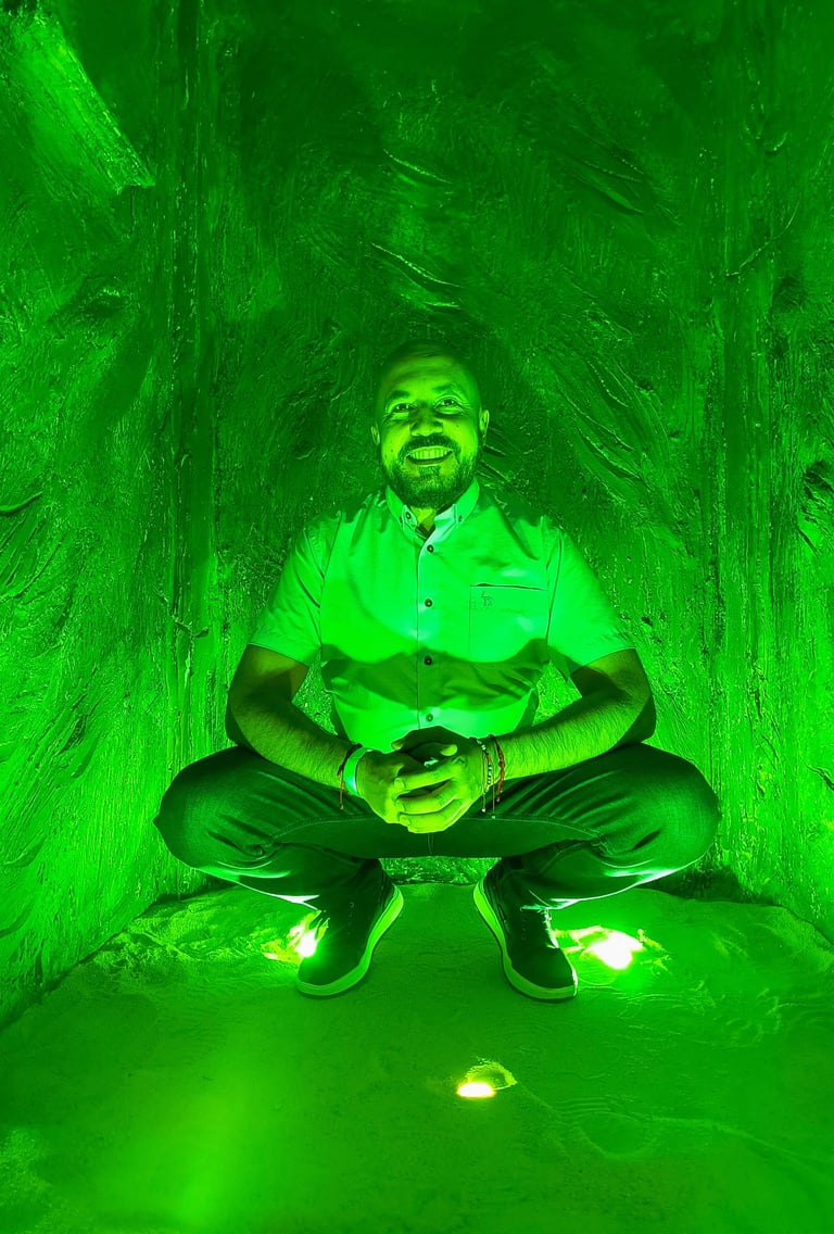 a man sitting in a tunnel with a green light