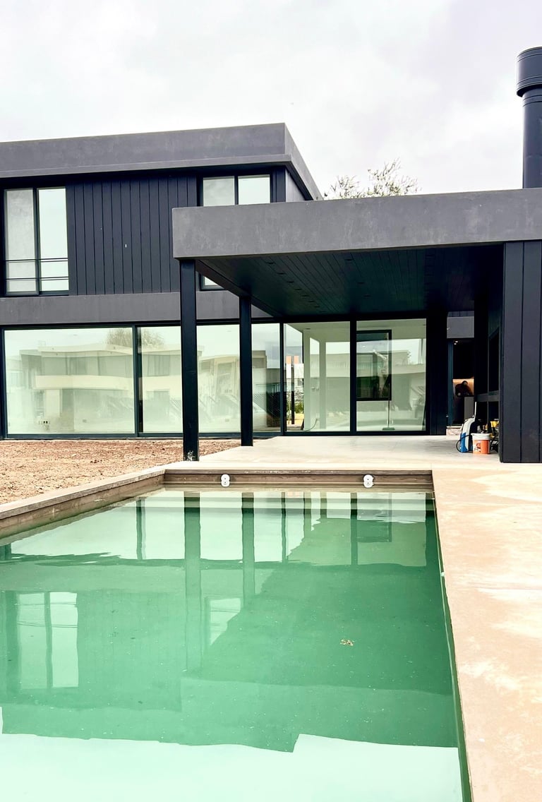 a pool with a large pool and a large house
