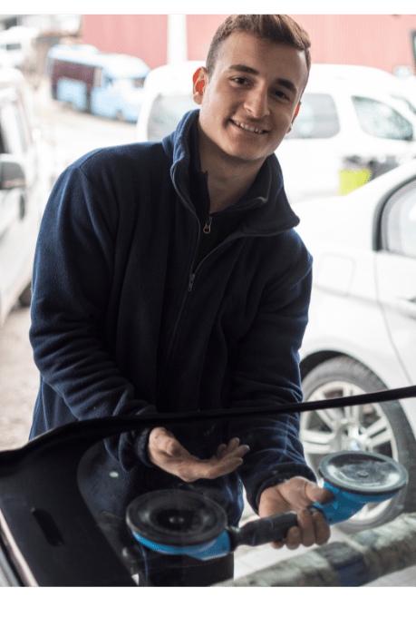 a man is holding a car with a car washer