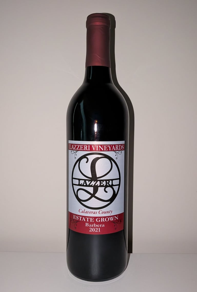 A single bottle of red wine labeled "Estate Grown Barbera"
