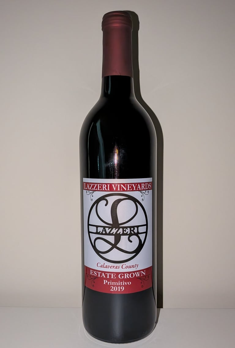 A single bottle of red wine labeled "Estate Grown Primitivo"