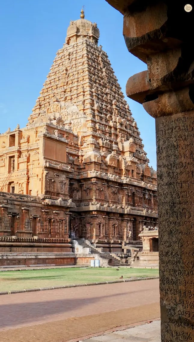 View of the Big Temple through carved pillars with ancient Tamil writing