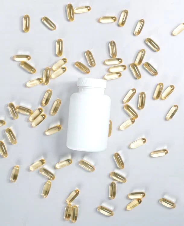 a bottle of vitamin supplements pills and capsules