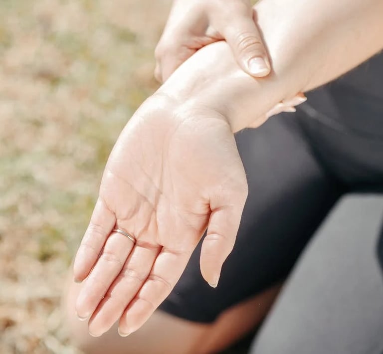 a woman holding her hand out to show off her hand