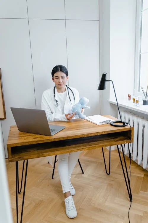 a woman in a white lab coat and a stethoscope