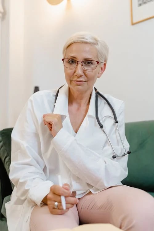 a woman doctor in a white lab coat and glasses