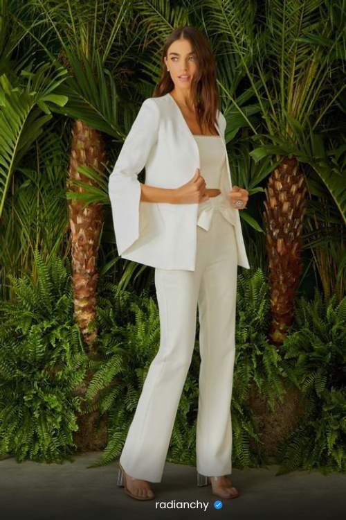 a woman in a white suit and heels