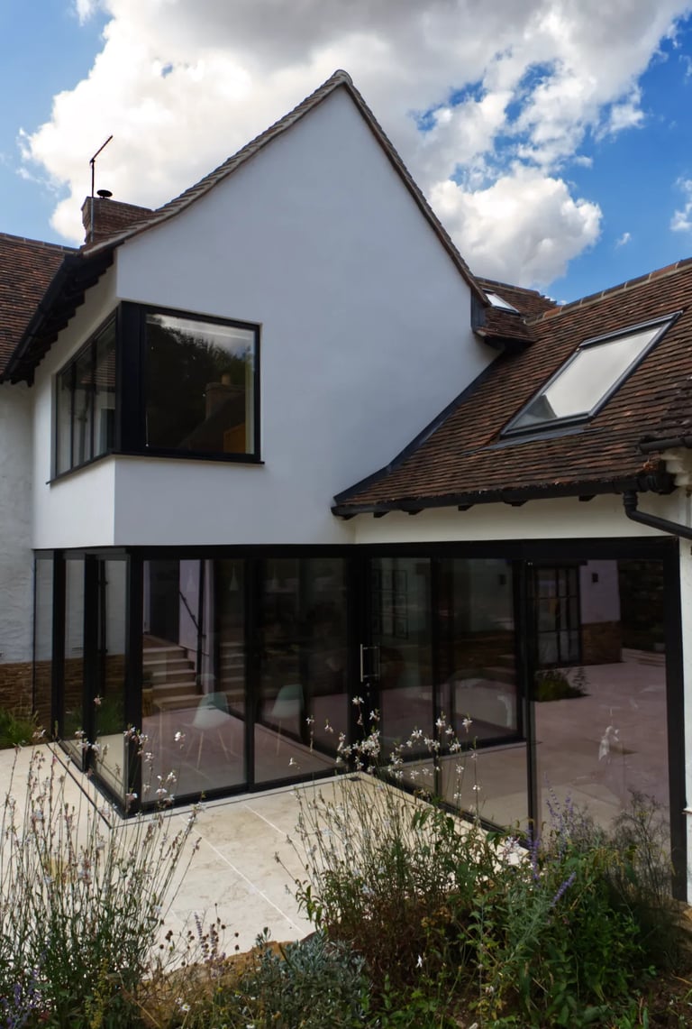 Large sliding doors and glazing creating a modern aesthetic to a home extension.