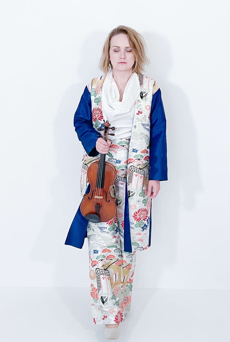 Portrait of Žydrė in traditional Japanese-inspired dress, eyes closed in contemplation while holding violin