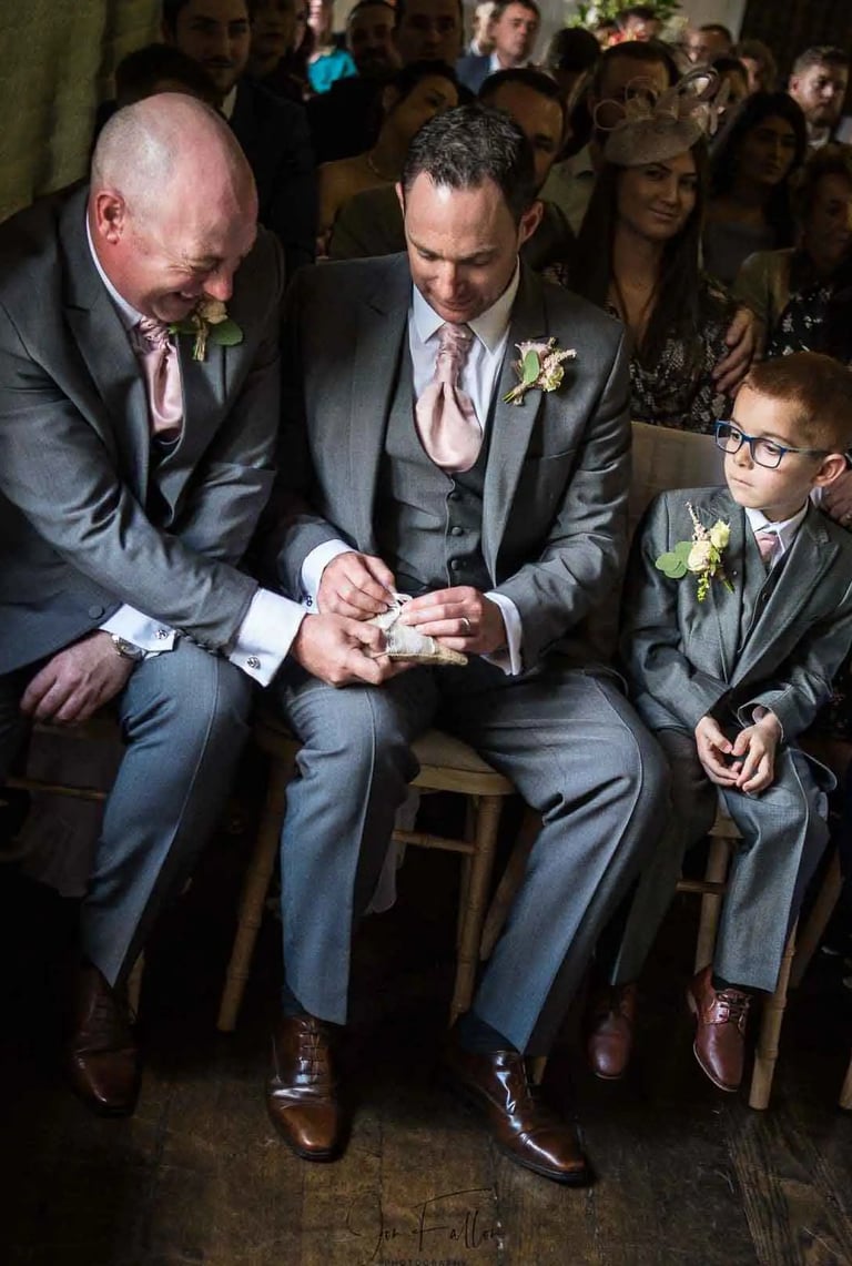 best man trying to find the wedding rings at the ceremony