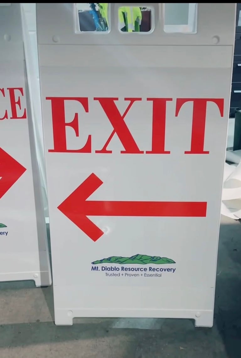 White plastic A-frame sign with red Exit text and arrow for Mt. Diablo Resource Recovery facility.