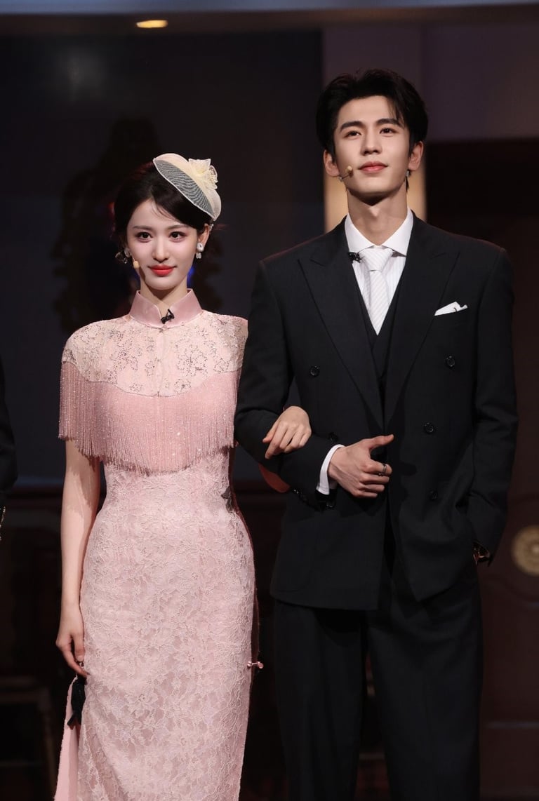 Actors Zhang Jingyi and Zhang Linghe pose in elegant pink lace cheongsam and a black tuxedo.