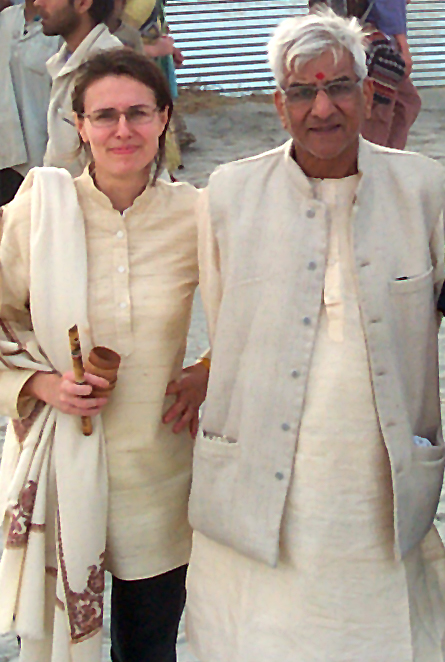 A woman and an elderly man posing together in traditional Indian kurta tunics and vests.