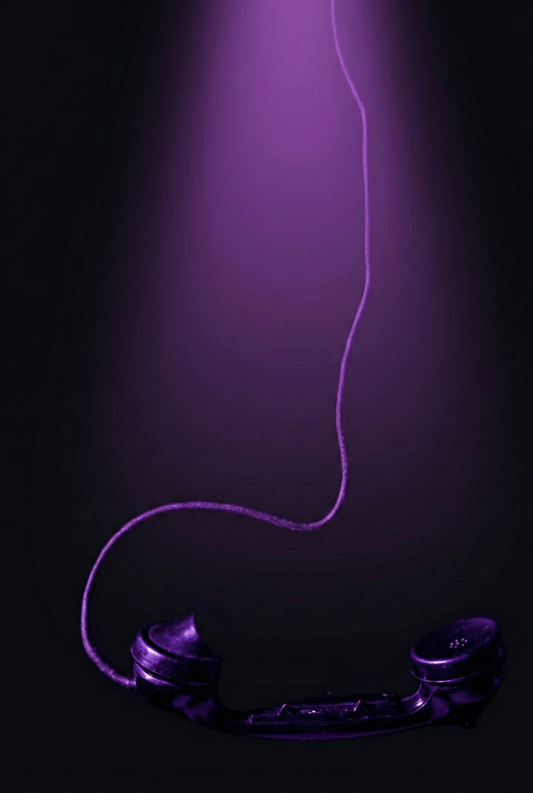 a telephone booth with a purple light shining on it