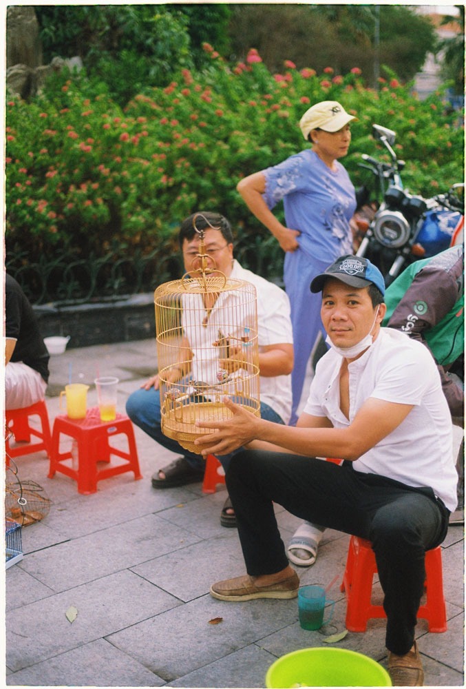 Three Vietnamese man on the bird market in Saigon China town