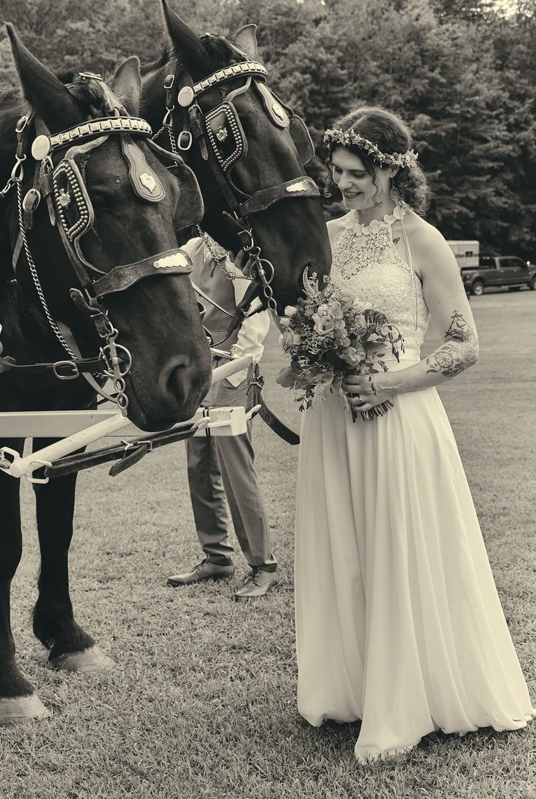 a bride and groom standing next to a horse drawn carriage