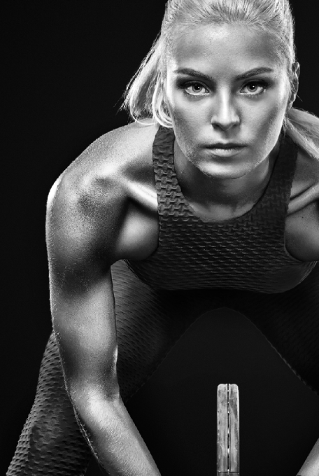 a female tennis player in a sports top with a tenns racket