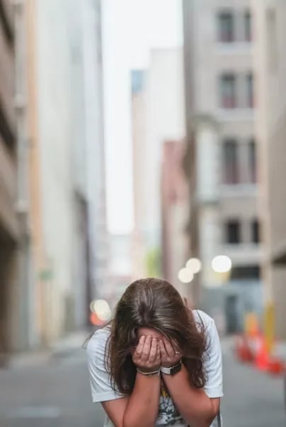 a woman covering her face wondering why God allows suffering