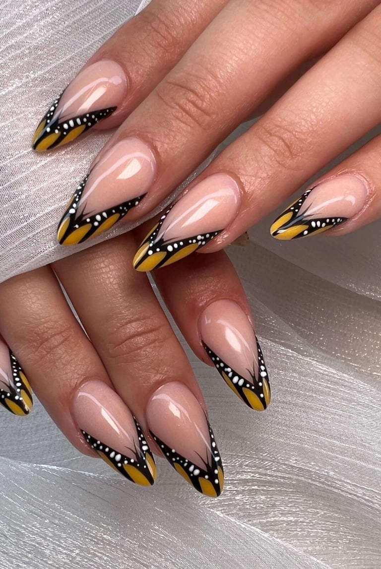 Nude fall nails with silver glitter French tips and 3D butterfly accents.