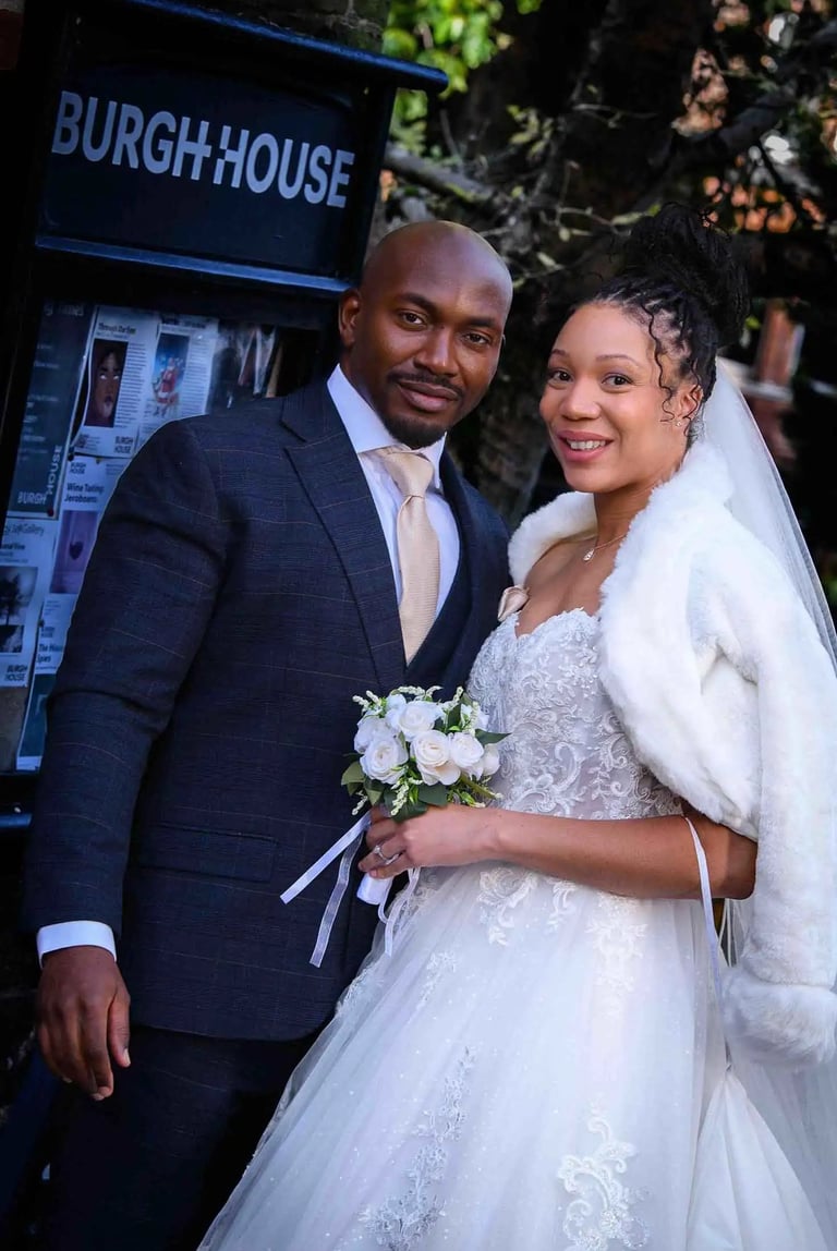 newly-weds standing outside the main gate of Burgh House Hampstead