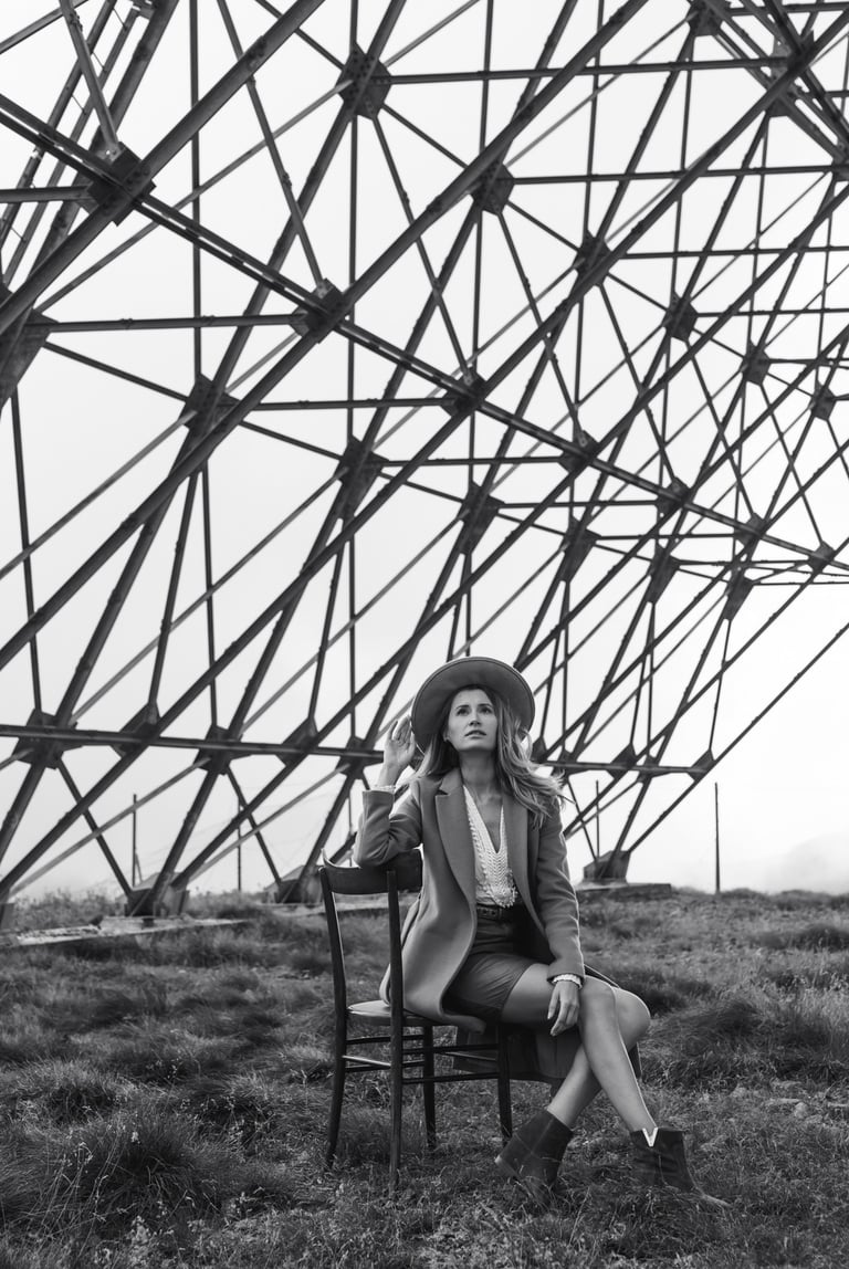 a woman sitting on a chair in a field