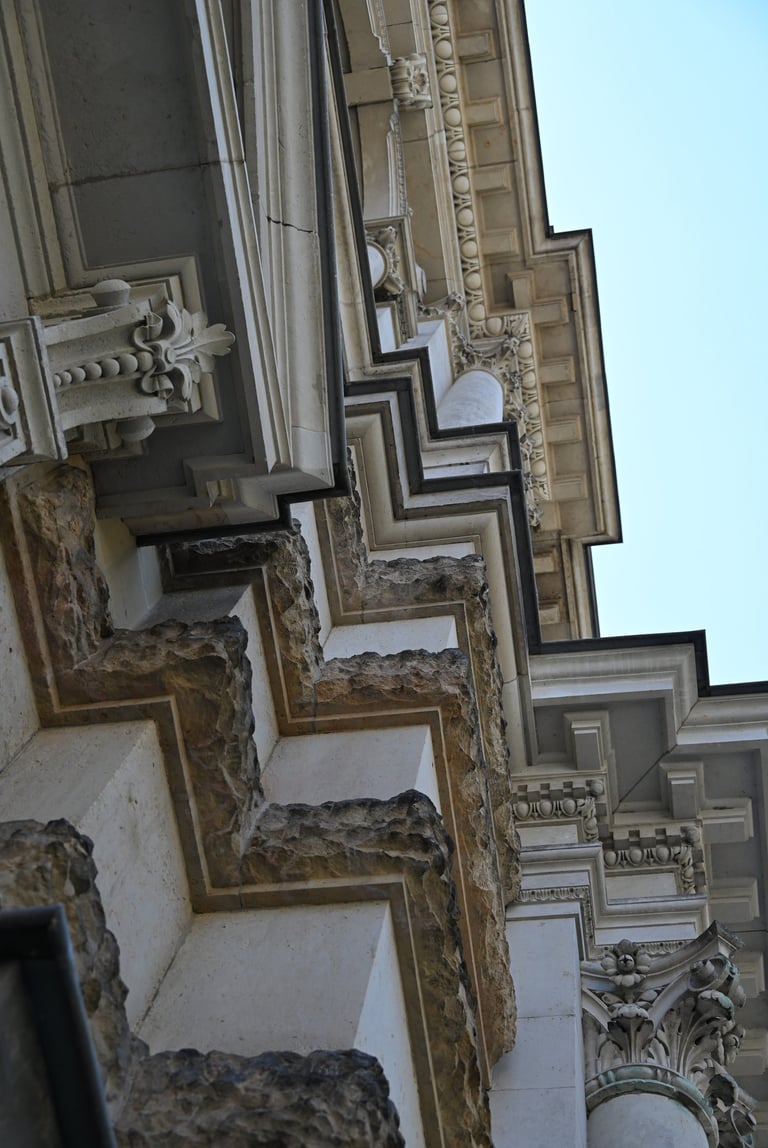Ornate stone facade with neoclassical architectural details, columns, and intricate carvings.