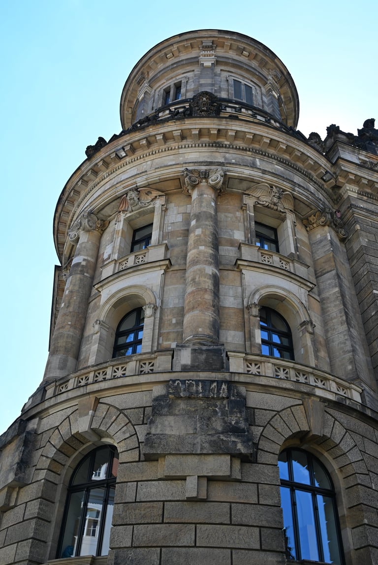 Low angle view of the historic building facade featuring neoclassical architecture.