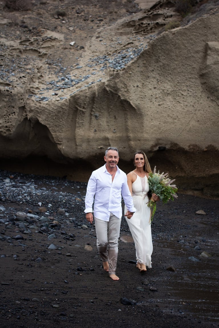 Couple walking on the beach during their wedding photoshoot.